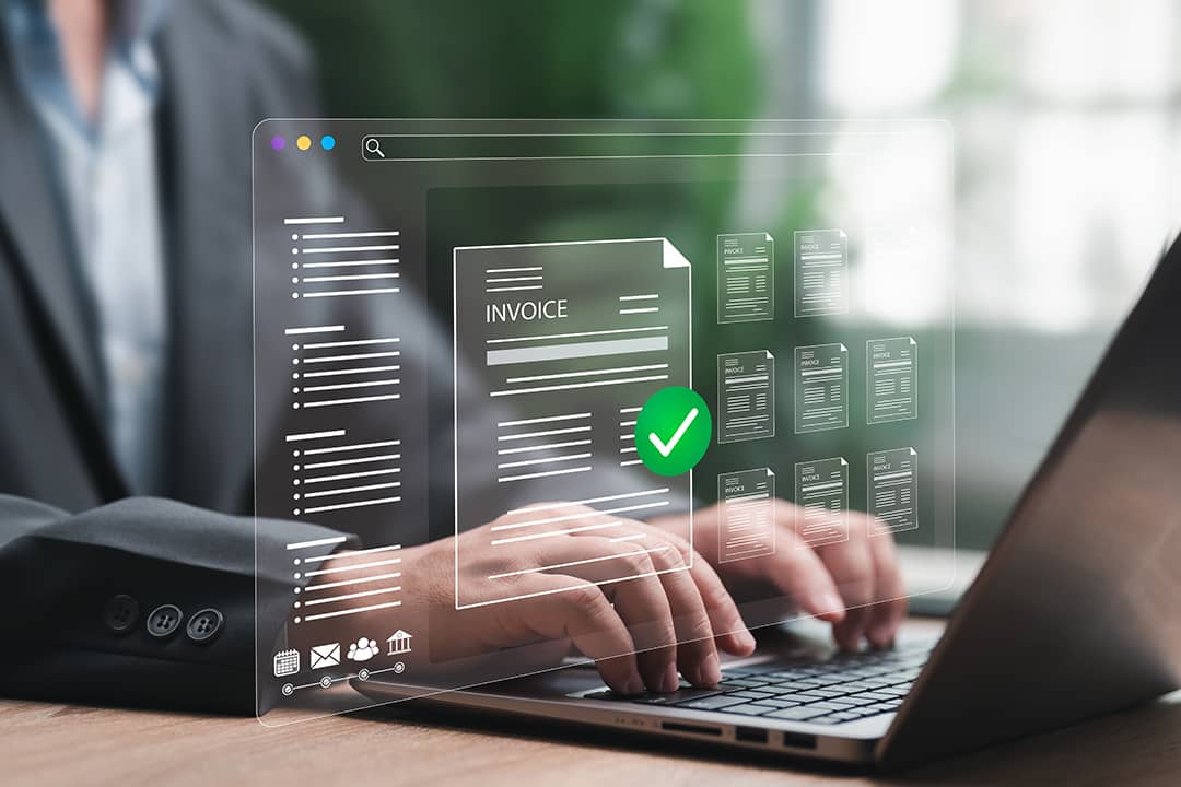 A finance officer processing an automated and digital invoice in an office laptop.